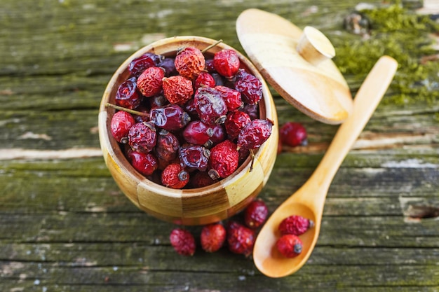 Dry berries in a wooden pot with a spoon