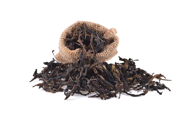 Dry black tea leaves isolated on a white background