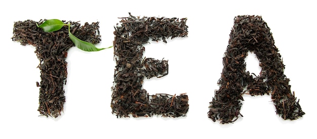 Dry black tea with green leaves isolated on white