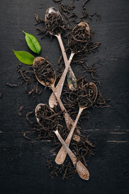 Dry black tea On a wooden background Top view Copy space