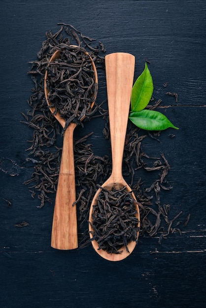 Dry black tea On a wooden background Top view Copy space