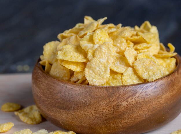 Dry breakfast corn flakes of yellow color close up