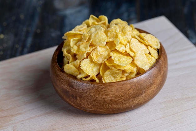 Dry breakfast corn flakes of yellow color close up