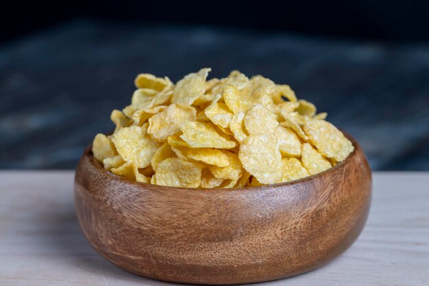 Dry breakfast corn flakes of yellow color close up