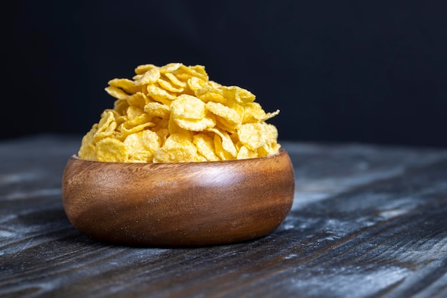 Dry breakfast corn flakes of yellow color close up