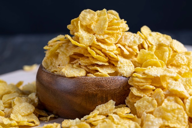 Dry breakfast corn flakes of yellow color close up