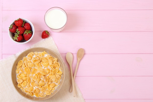 Dry breakfast in a plate on a colored background top view cereal