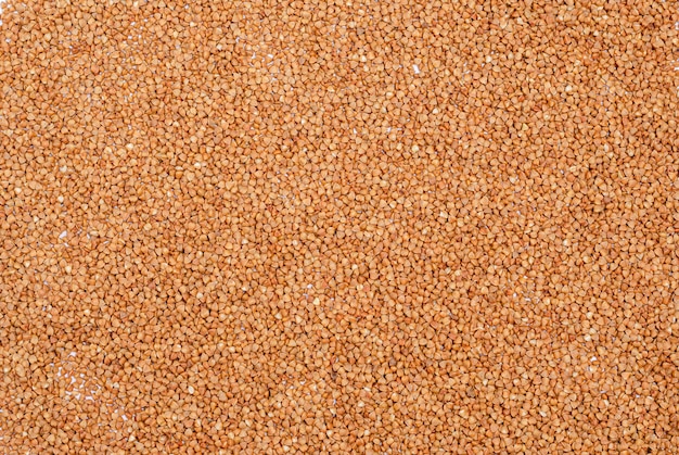 Dry buckwheat groats for vegans in the form of a background.