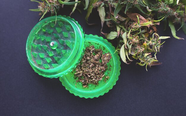 Dry cannabis bud and grinder, classic use of marijuana.