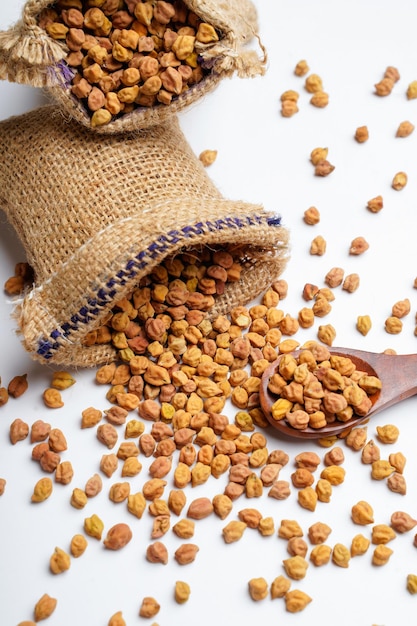 Dry chickpea in bag over white background.