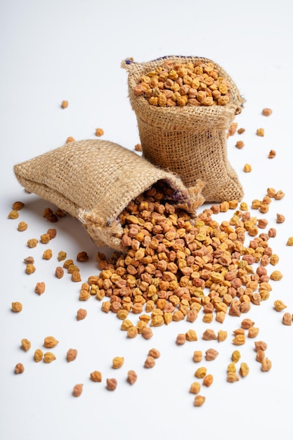 Dry chickpea in bag over white background.