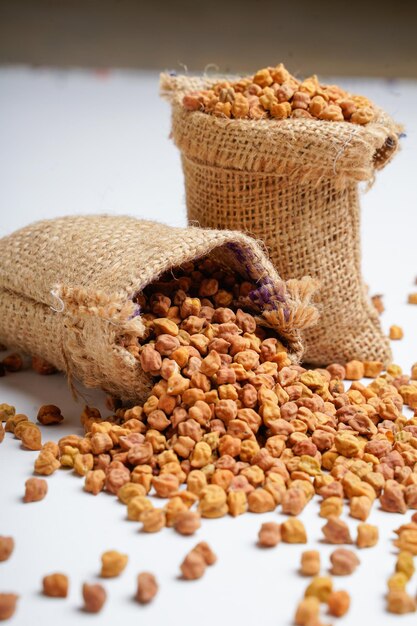 Dry chickpea in bag over white background.