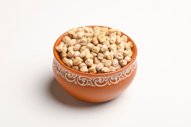 Dry chickpea in bowl on white background.