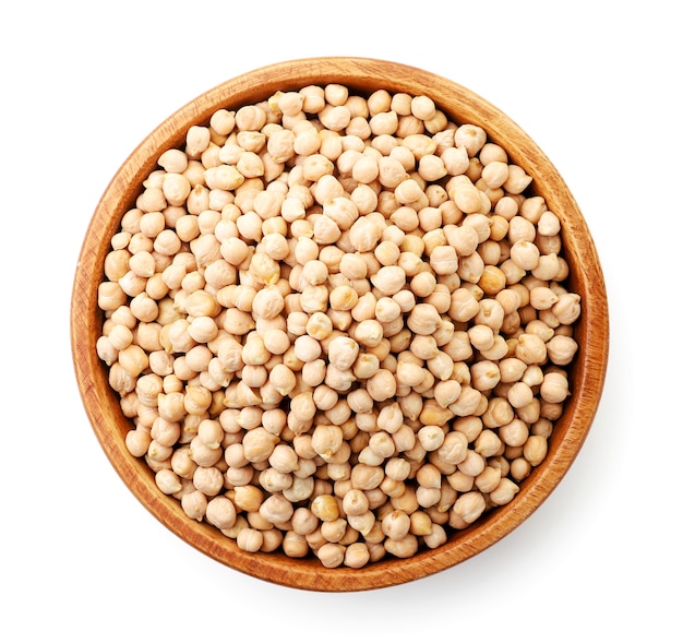 Dry chickpeas in a wooden plate close-up on a white background, isolated. The view from top