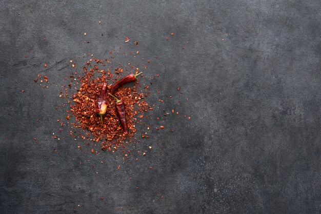 Dry chili peppers on a black surface