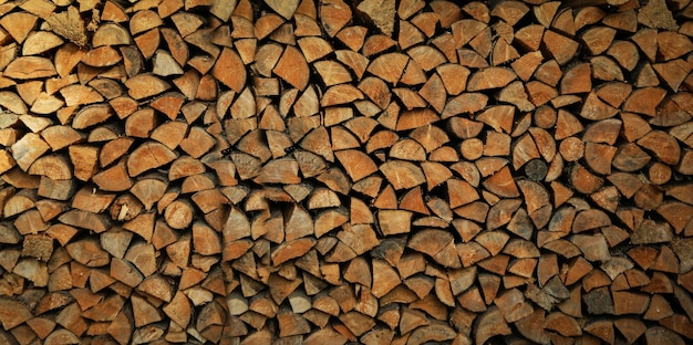 Dry chopped firewood logs in a pile