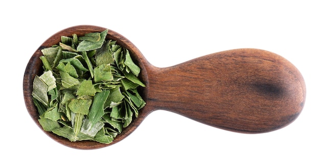 Dry chopped spring onion in wooden spoon isolated on white background Dried green onion or scallion Spices and herbs Top view