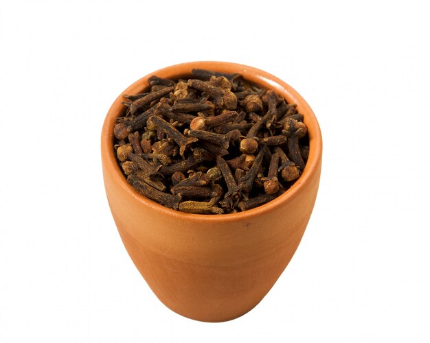 Dry cloves in a bowl on white background. 