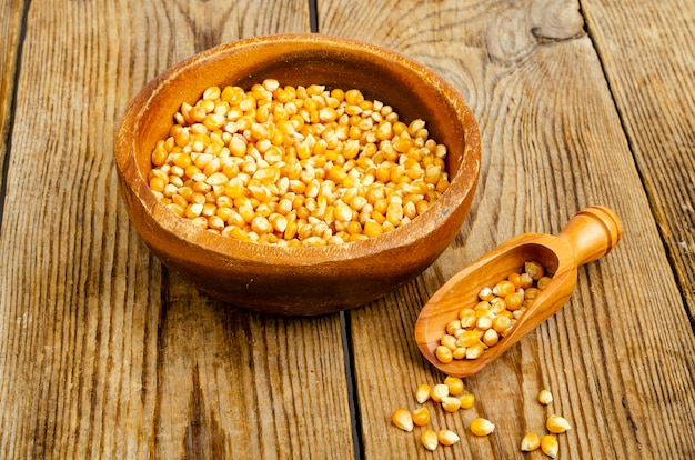 Dry corn grains in bowl for making popcorn