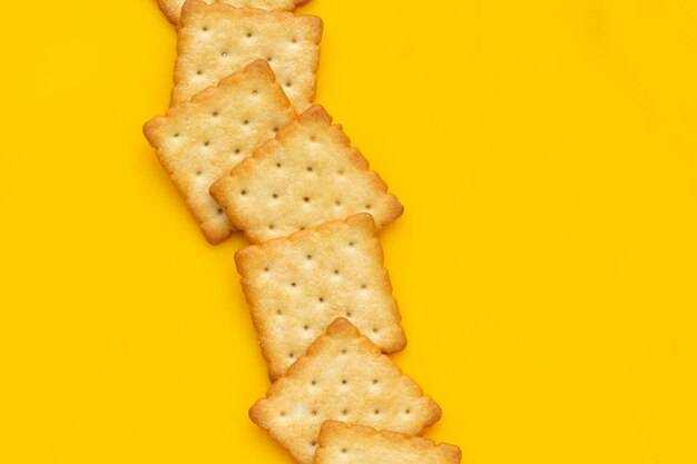 Dry cracker cookies on yellow background