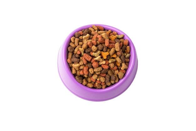 Dry food for cats and dogs in a red bowl on a white background top view