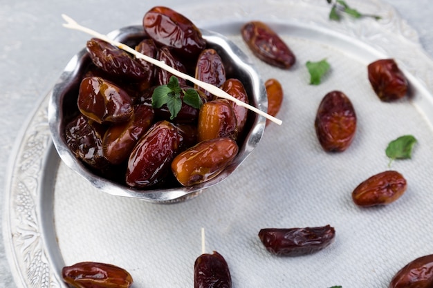 Dry fruit dates on silver tray. Top view.