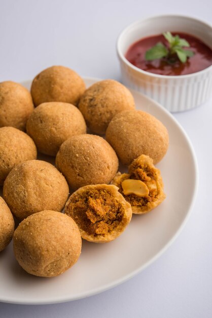 Dry fruit kachori is small and round shape ball stuffed with masala and cashew etc, served with tomato ketchup and hot tea, haldiram product