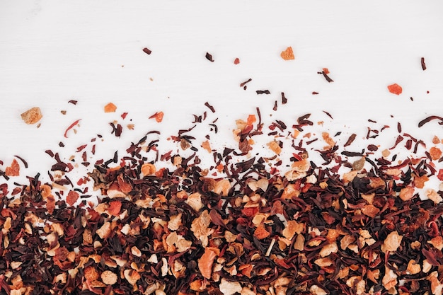 Dry fruit tea randomly scattered on a white table background. Top view. Copy, empty space for text