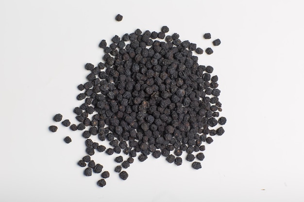 dry fruits of Prunus spinosa Blackthorn fruits on a white isolated background for spices seasonin