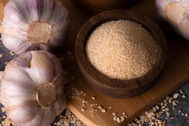 Dry garlic granules Spice garlic Dry garlic powder in a wooden bowl and spoon