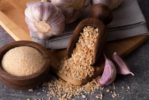 Dry garlic granules Spice garlic Dry garlic powder in a wooden bowl and spoon