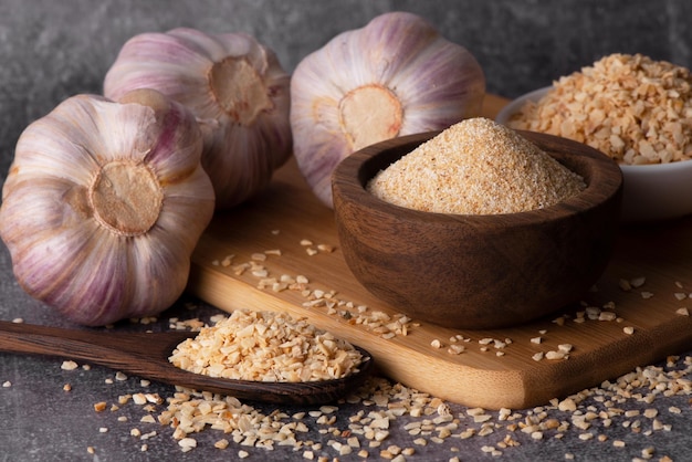 Dry garlic granules Spice garlic Dry garlic powder in a wooden bowl and spoon