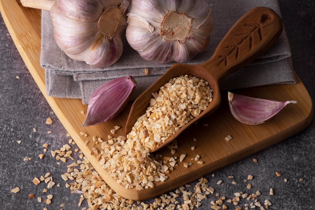 Dry garlic granules Spice garlic Dry garlic powder in a wooden bowl and spoon