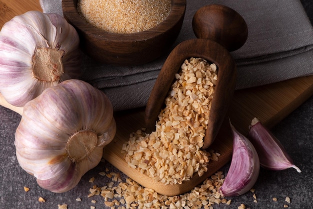 Dry garlic granules Spice garlic Dry garlic powder in a wooden bowl and spoon