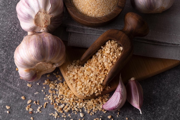 Dry garlic granules. Spice garlic. Dry garlic powder in a wooden bowl.