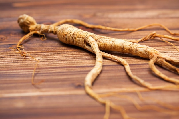 Dry ginseng on a wood background