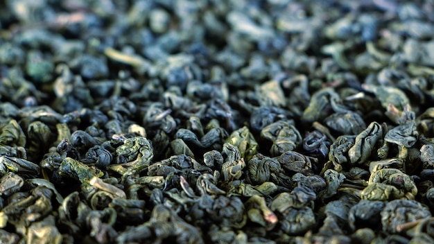 Dry green tea, texture. Natural abstract background.