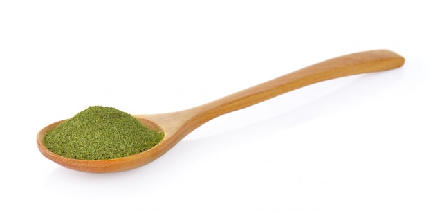 Dry green tea in wood spoon