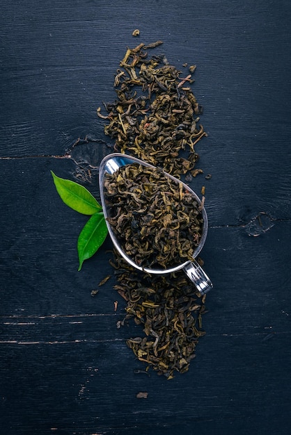 Dry green tea On a wooden background Top view Copy space