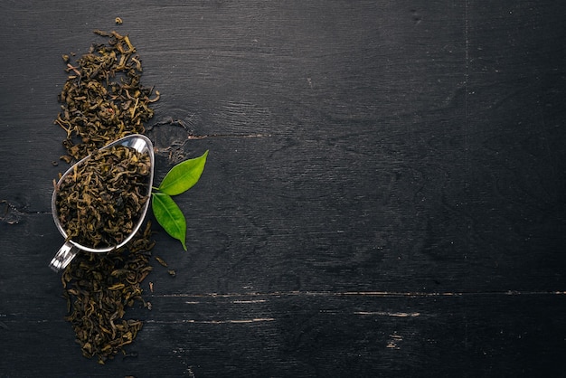 Dry green tea On a wooden background Top view Copy space