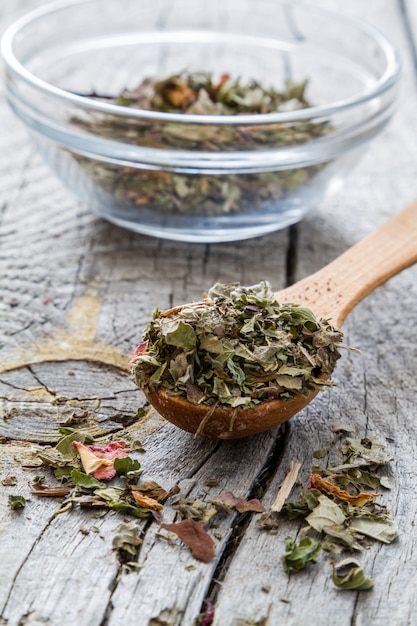Dry herb tea in wood spoon