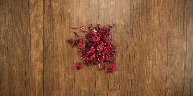 Dry hibiscus petals on wooden table