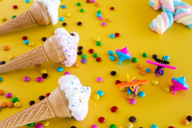 Dry ice cream and plastic toys on yellow background