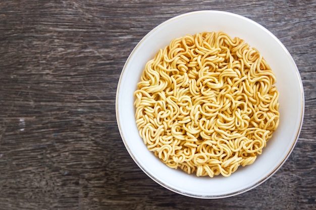 Dry instant noodle on white bowl.