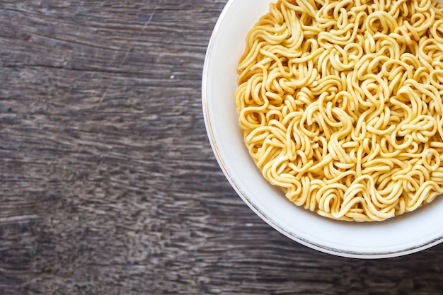 Dry instant noodle on white bowl.