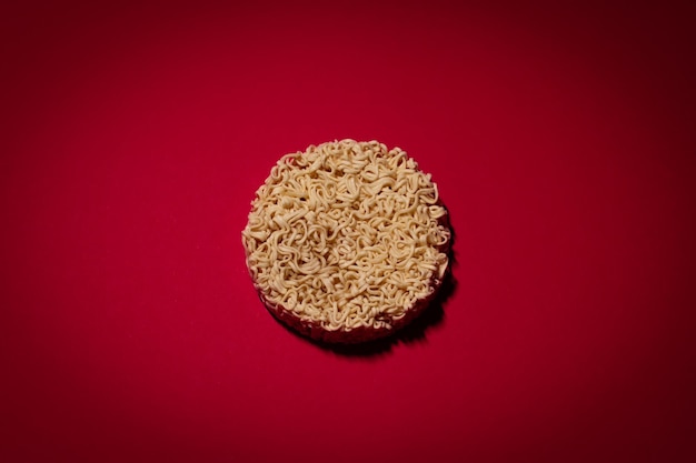 Dry instant noodles on the red background