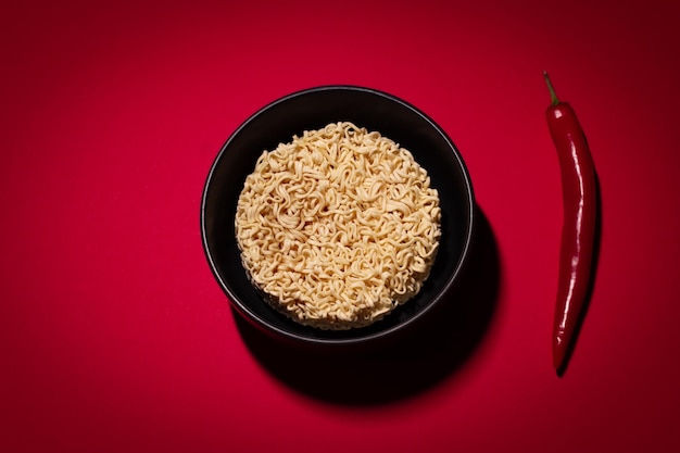 Dry instant noodles on the red background