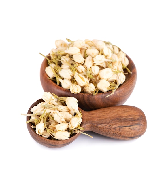 Dry jasmine flowers in wooden bowl and spoon isolated on white background Jasmine flowers tea Herbal tea