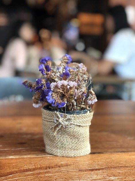 Dry lavender flower craft sack bouquet vest on wooden table cafe 