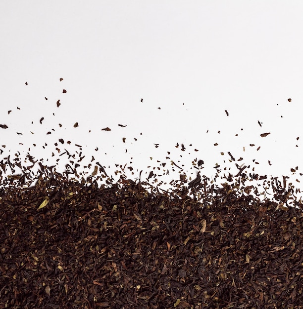 Dry leaves of darjeeling black tea on white background